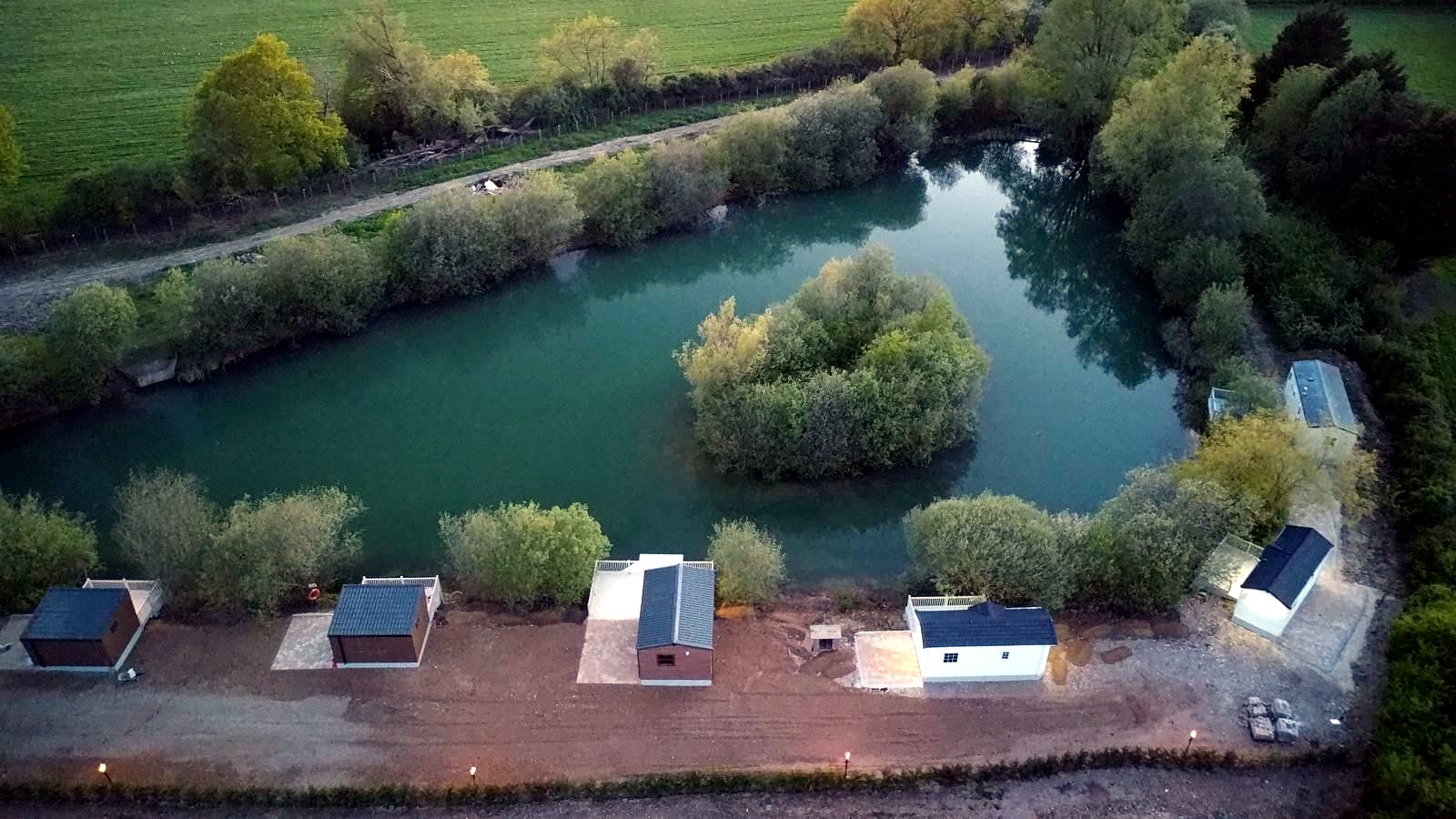 Wide view across the coarse fishing lakes at Morgans Farm Fishery, Essex — replace with a photo of the water